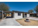 View of front yard of this single Gathering home with gray paint and desert landscape at 826 S Drew St, Mesa, AZ 85210