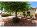 Charming single story home with a two-car garage and xeriscaped front yard and red tile roof at 8341 W Cypress St, Phoenix, AZ 85037