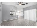 Open concept living area with modern flooring and neutral paint, seamlessly connected to a breakfast bar at 8341 W Cypress St, Phoenix, AZ 85037