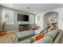 Cozy living room with archway, and a mounted television, and lots of natural light at 880 S 150Th Dr, Goodyear, AZ 85338