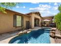 Resort-style pool area with a tanning ledge, spa, and outdoor dining space at 9262 E Desert Park Dr, Scottsdale, AZ 85255