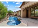 Backyard oasis with a sparkling pool, waterfall feature, and relaxing spa at 9262 E Desert Park Dr, Scottsdale, AZ 85255