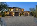 Impressive home exterior with multi-car garages, stone accents, and a spacious paver driveway at 9290 E Thompson Peak Pkwy # 470, Scottsdale, AZ 85255