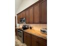 Modern kitchen featuring stainless steel oven and microwave, custom wood cabinets and granite countertops at 10029 S 44Th St, Phoenix, AZ 85044