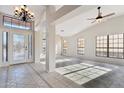 Bright and airy foyer with tile flooring, a decorative chandelier, and high ceilings at 1192 E Sunset Dr, Casa Grande, AZ 85122