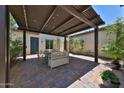 Relaxing outdoor patio featuring a shaded pergola, beautiful pavers, and comfortable seating, perfect for entertaining at 17082 S 182Nd Ave, Goodyear, AZ 85338