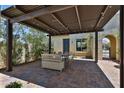 Charming outdoor patio with a covered pergola, stylish pavers, and a comfortable seating area for relaxing at 17082 S 182Nd Ave, Goodyear, AZ 85338
