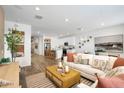 Open-concept living area with hardwood floors, ample natural light, and modern décor at 17962 W Sand Hills Rd, Surprise, AZ 85387