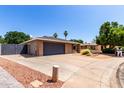 Single story brick home with a two car garage and desert landscaping at 1804 S Standage Cir, Mesa, AZ 85202