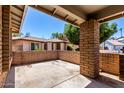 View of the patio with brick pillars, looking out onto neighboring houses at 1804 S Standage Cir, Mesa, AZ 85202