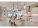Modern kitchen features a large island with seating and stylish pendant lighting at 19910 W Mulberry Dr, Buckeye, AZ 85396