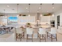 Bright and spacious kitchen featuring a large island with pendant lighting and modern appliances at 19910 W Mulberry Dr, Buckeye, AZ 85396