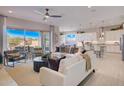 Open-concept living room with comfortable seating and access to outdoor patio at 19910 W Mulberry Dr, Buckeye, AZ 85396