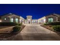 Stunning home exterior featuring an extended driveway and meticulously maintained landscaping at nighttime at 20115 E Sonoqui E Blvd, Queen Creek, AZ 85142