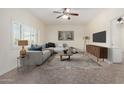 Cozy living room features a comfortable sectional, stylish rug, and abundant natural light at 2547 W Naranja Ave, Mesa, AZ 85202