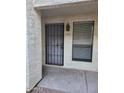 A closer shot of an apartment entrance featuring a security door and a window with blinds at 3119 W Cochise Dr # 148, Phoenix, AZ 85051