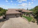 Aerial view of single-story home with tile roof, desert landscaping, and a three-car garage at 31234 N 47Th Pl, Cave Creek, AZ 85331