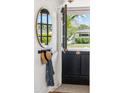 Stylish entryway with a round mirror, coat hooks, and a view of the outdoors at 3201 E Colter St, Phoenix, AZ 85018