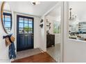 Inviting entryway featuring a stylish front door, wood floors, and patterned tile at 3201 E Colter St, Phoenix, AZ 85018