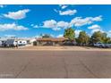 Street view of a cozy single story home with desert landscaping, covered parking, and a clear blue sky backdrop at 3649 E Delcoa Dr, Phoenix, AZ 85032