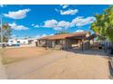Cozy home with desert landscaping, carport, and clear, inviting driveway and walkway at 3649 E Delcoa Dr, Phoenix, AZ 85032