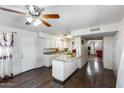 Spacious eat-in kitchen boasts granite countertops, a ceiling fan, and modern appliances, great for cooking at 3807 N 56Th Dr, Phoenix, AZ 85031