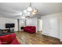 Cozy living room features a stone fireplace, hardwood floors, and ample seating, creating a welcoming atmosphere at 3807 N 56Th Dr, Phoenix, AZ 85031