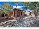 Inviting single-story home with desert landscaping, shade trees, and a welcoming front porch at 3850 E Geronimo St, Gilbert, AZ 85295