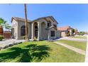 Charming two story home with desert landscaping, palm trees, and a stucco exterior at 4331 E Redwood Ln, Phoenix, AZ 85048