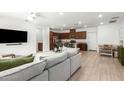 Open-concept living area with views of the kitchen and dining space, perfect for entertaining at 4562 S Park Grove St # 101, Gilbert, AZ 85297