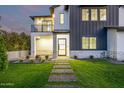 Charming two-story home with a well-manicured lawn and inviting walkway leading to the entrance at 4813 E Earll Dr, Phoenix, AZ 85018
