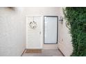 Close-up of a charming white front door with a decorative wreath and a 'Welcome' mat at 5515 E Elena Ave, Mesa, AZ 85206