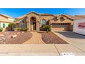 Inviting single-story home featuring a two car garage, desert landscaping and a brick walkway at 5731 W Gail Dr, Chandler, AZ 85226