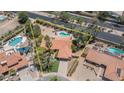 Aerial view showcasing the property with a pool, lush landscaping, and a tile roof at 6101 E Beck Ln, Scottsdale, AZ 85254