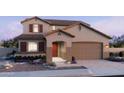 Inviting two-story home featuring neutral tones, a two-car garage, and lovely landscaping at 713 W Longwood Dr, Queen Creek, AZ 85140