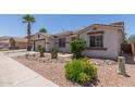 Charming single-story home featuring desert landscaping, a neutral color palette, and a two-car garage at 7205 W Ellis St, Laveen, AZ 85339