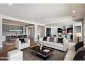 Spacious living room with an open concept layout, stylish furniture, and neutral color scheme at 7205 W Fallen Leaf Ln, Peoria, AZ 85383