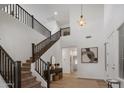 Spacious entryway featuring a staircase, high ceilings, and modern decor at 7616 S Sorrell Ln, Gilbert, AZ 85298