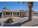 Tan home with a desert rock yard and front patio cover at 906 Leisure World --, Mesa, AZ 85206