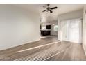 Open-concept living room featuring laminate flooring and access to the kitchen at 10225 W Camelback Rd # 33, Phoenix, AZ 85037
