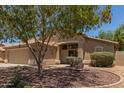 Charming one-story home showcasing a tile roof and lovely desert landscaping at 10318 E Plata Ave, Mesa, AZ 85212