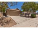 View of the front of the home, showing the driveway and two-car garage at 10318 E Plata Ave, Mesa, AZ 85212