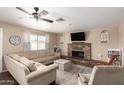 Comfortable living room with a large sectional sofa, brick fireplace, and ample natural light at 1263 W Del Rio St, Chandler, AZ 85224