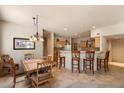 Open-concept dining area with tiled floors seamlessly flows into a kitchen with breakfast bar seating at 12642 N Mountainside Dr # D, Fountain Hills, AZ 85268