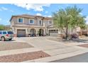Beautiful two-story home with a circular driveway, three-car garage, and well-maintained landscaping at 14161 W Poinsettia Dr, Surprise, AZ 85379