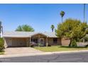 Attractive single-story home with covered parking and well-maintained front yard at 1454 W Capri Ave, Mesa, AZ 85202