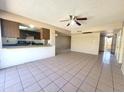 Open-concept living room with tile floors open to kitchen at 15602 N 55Th Ave, Glendale, AZ 85306