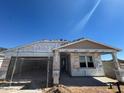 New home construction featuring a covered entryway and a two-car garage under a clear, blue sky at 16174 W Bajada Rd, Surprise, AZ 85387