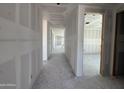 Long hallway with drywall installed, leading to spacious rooms, and featuring smooth, gray concrete floors at 16174 W Bajada Rd, Surprise, AZ 85387