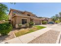 Charming two-story home featuring a well-manicured lawn and a two-car garage at 17419 W Elaine Dr, Goodyear, AZ 85338